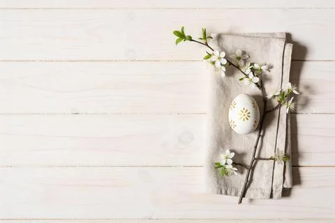 Elegant Easter egg with delicate blossoms on a rustic wooden background Stock Photos