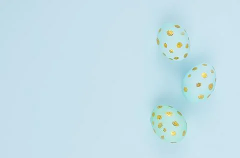 Elegant easter eggs with gold dots as border on blue background, copy space,  Stock Photos