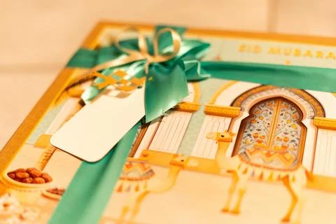 Elegant Eid Mubarak Gift Box with Decorative Islamic Design and Green Ribbon Stock Photos