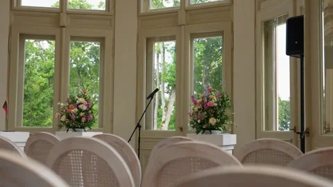 Elegant Empty Wedding Ceremony Room With Floral Arrangements and Large Windows Stock Footage 345234935