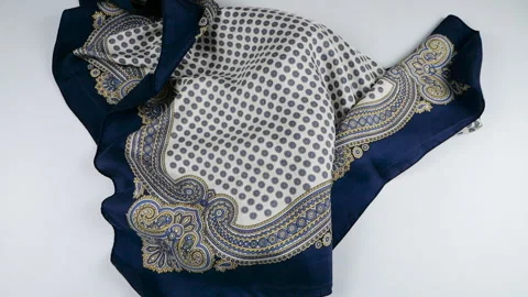 The elegant fabric in navy blue, light blue, and beige shades flows falls. Stock Footage 337402467