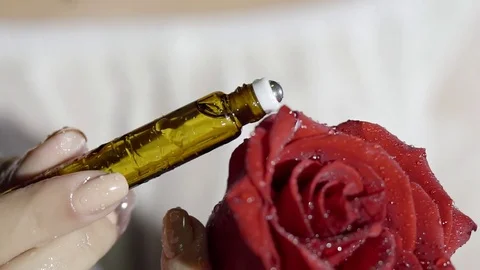 Elegant female hands with beautiful manicure applied the aromatic oil from the g Stock Footage