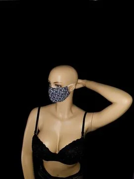 Elegant Figure Showcases Patterned Face Covering. Minimalist Studio Scene F.. Stock Photos
