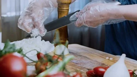 Elegant fine dining angle: cutting beef into pieces for stewing Stock Photos