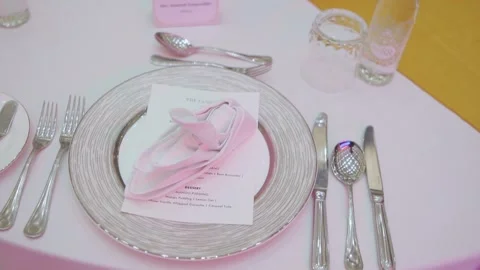 Elegant fine dining table setting with luxury plates and wine glasses at a Stock Footage 336289480