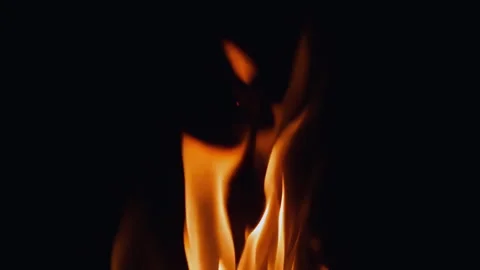 An Elegant Flame is Dancing Gracefully Against a Dark Background, Creating a Stock Footage 295889211