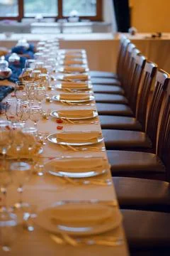 Elegant formal dining table setting with chairs and place settings for a ba.. Stock Photos
