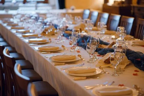 Elegant formal dining table setting with white tablecloth and place setting.. Stock Photos