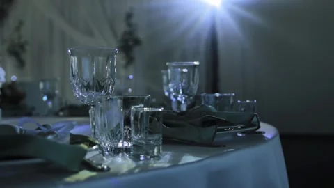Elegant formal table setup for celebration event featuring various crystal Stock Footage 344864858