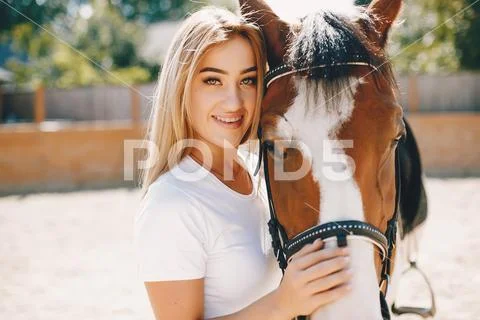 Elegant girl in a farm wiith a horse Stock Photos