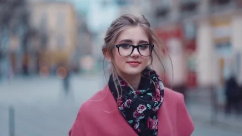 Elegant girl in a stylish look,walking down street and looking right to camera Stock Footage