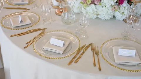 Elegant Gold Table Setting with Floral Centerpiece for Luxurious Wedding Stock Footage 345095035