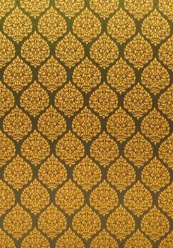 Elegant golden thread repeating pattern over a textile surface. Close up shot. Stock Photos