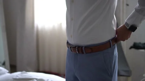 Elegant guy fixing a belt Video stock 232767030