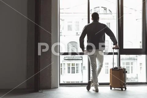 Elegant guy is holding his bag Stock Photos