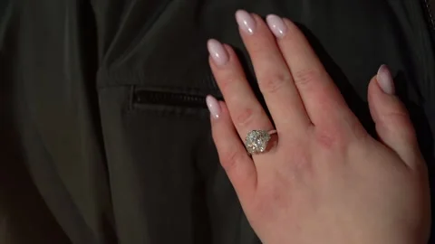 An Elegant Hand Displaying a Ring on a Beautiful Dark Fabric Background for Stock Footage 314577399