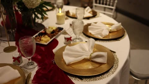 Elegant holiday dinner table with gold place settings Stock Footage 337589473