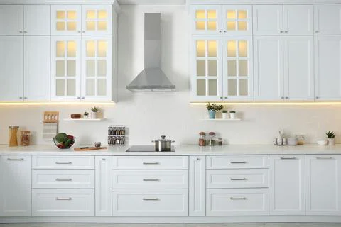 Elegant kitchen interior with modern stove and stylish furniture Stock Photos