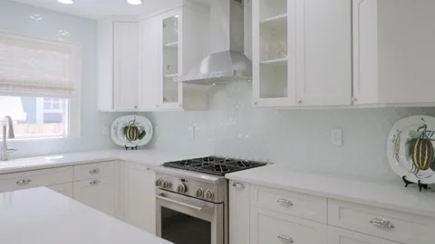 Elegant kitchen interior with white cabinets and stainless steel appliances with Stock Footage 275904759