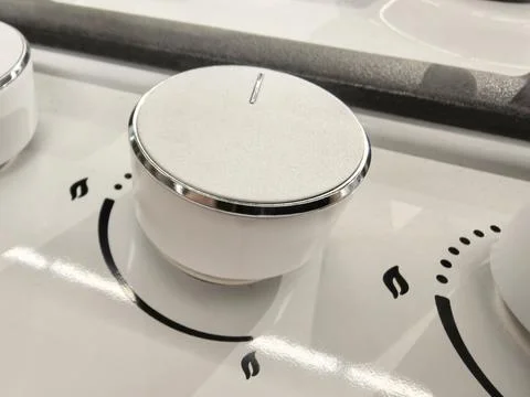 Elegant knobs on a modern kitchen stove invite culinary adventures Fotos de archivo