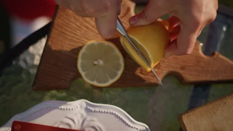 Elegant lemon slices set on rustic porcelain tray outdoors. Vivid yellow citrus Stock Footage 331371259