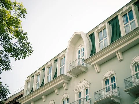 Elegant light green building with white trim and arches Stock Photos