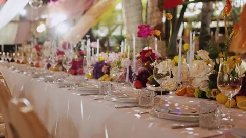 Elegant long dining table at a wedding in a restaurant, festive decor with Stock Footage 323451238