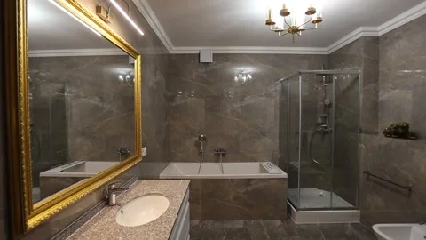 Elegant luxury bathroom interior with mirror, sink, glass shower cabin, bidet Vídeos de archivo 337937558