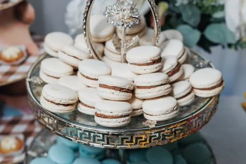 Elegant macarons stack on a decorative glass stand 스톡 사진