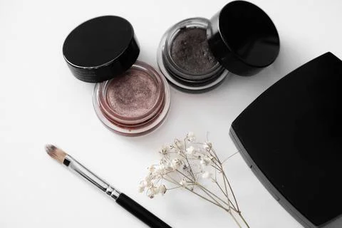 Elegant Makeup Essentials with Flowers Stock Photos