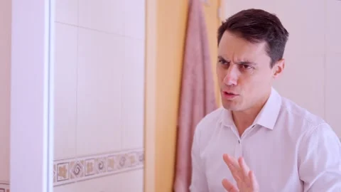 Elegant man applying perfume in bathroom mirror Stock-Footage 312549285