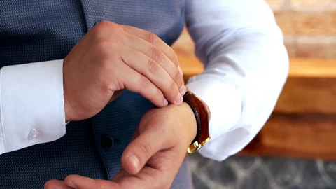 Elegant man puts on a clock on hand. Close-up Stock Footage 115434105