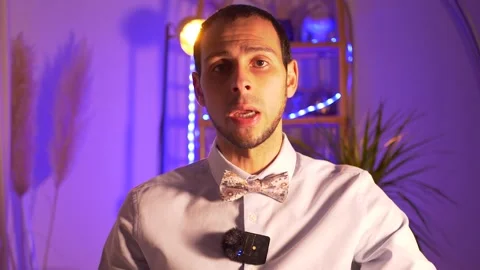 Elegant man speaks in front of the camera Stock Footage 233566927