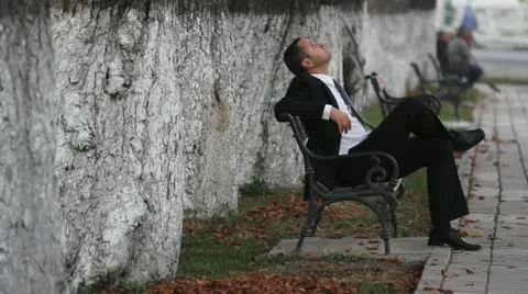 Elegant man with suit resting on the bench Stock Footage 12467784
