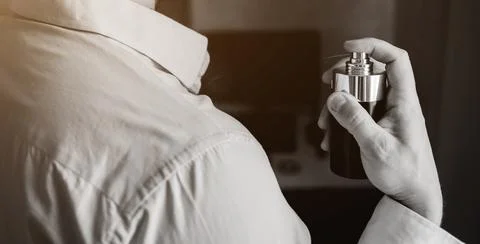 Elegant man using perfume. Stock Photos