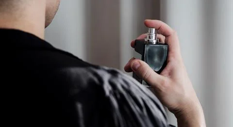 Elegant man using perfume Stock Photos