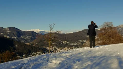 Elegant Man Using Smartphone and Making Photos and Joy Mountain View 動画素材 194011777