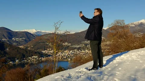 Elegant Man Using Smartphone and Making Photos and Joy Mountain View Stock Footage 194011781