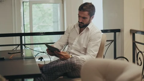 Elegant man using tablet in a cafe in the morning Stock Footage 96296728