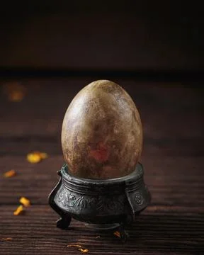 Elegant marble-painted Easter egg on vintage stand Stock Photos