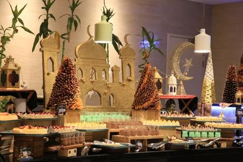 Elegant Middle Eastern-themed buffet with desserts, date towers and mosque Stock Photos