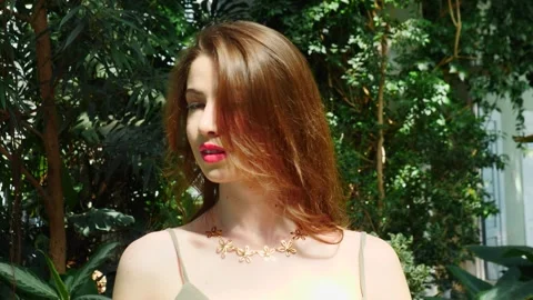 An Elegant Model Beautifully Posing in Lush Greenery While Wearing a Stunning Video stock 310539850
