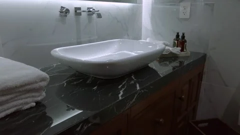 Elegant modern bathroom interior design with a marble counter and vessel sink Stock Footage 337263211