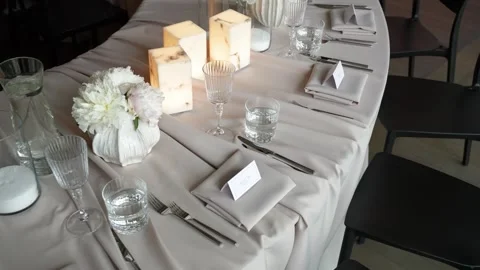 Elegant Modern Table Setting with Candles and White Floral Centerpieces Stock Footage 337435009