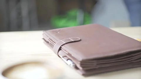 Elegant note pad book bullet journal habit tracker in light brown leather case h Stockbeeldmateriaal 137538639