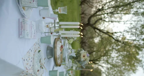 An Elegant Outdoor Dining Setup Featuring Beautiful Candles and a Stunning Stock Footage 305646973