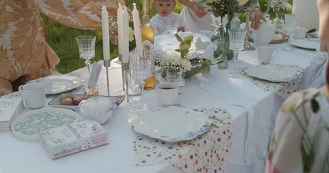 An Elegant Outdoor Dining Setup Featuring Beautiful Vintage Tableware for Stock Footage 306324540