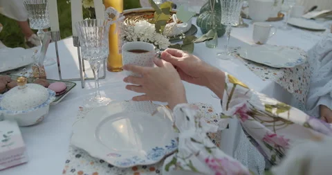 An Elegant Outdoor Dining Setup Featuring Exquisite Vintage Tableware for Stock Footage 306324898