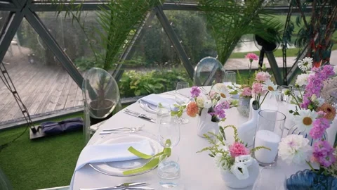 Elegant Outdoor Event Table Setting with Fresh Floral Decor in Glass Dome Stock Footage 345233655