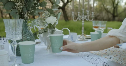 An Elegant Outdoor Table Setting Enhanced with Beautiful Floral Decor and Video stock 307931749